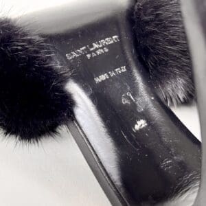 Close-up of black Saint Laurent shoe.
