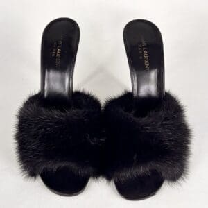 Black fur-embellished high-heeled sandals.