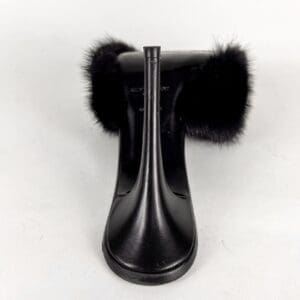 Black high-heel shoe with furry accents.