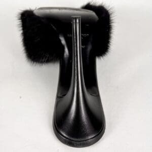 Black high heel with fur accents.