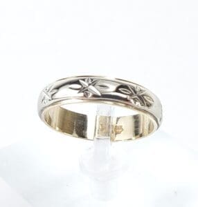 Gold ring with star engravings.