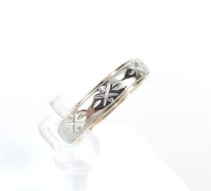 Silver ring with star engravings.