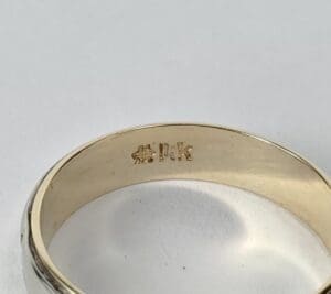 Gold ring with "14K" engraving inside band.