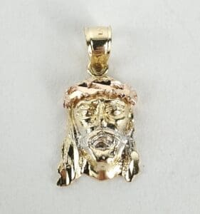 Gold Jesus pendant with crown of thorns.
