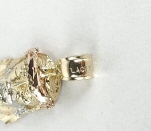 Gold and silver pendant on white background.