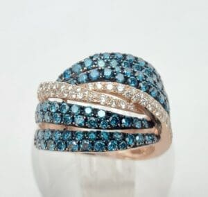 Gold ring with blue and white gemstones.