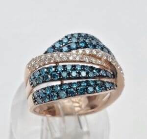Gold ring with blue and white stones.