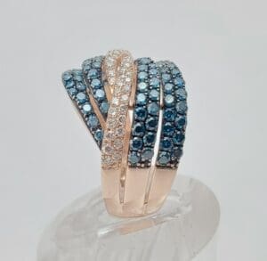 Gold ring with blue and white stones.