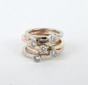 Stacked gold rings with diamond accents.