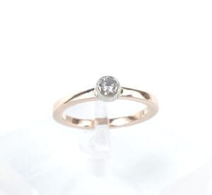 Gold ring with single round diamond.