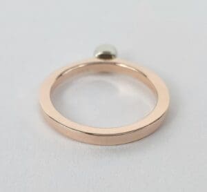 Gold ring with single round gem.
