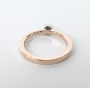 Gold ring with small diamond accent.