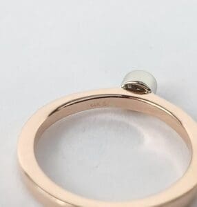 Gold ring with small round gemstone.