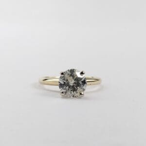 Diamond solitaire engagement ring on white background.