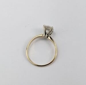 Gold ring with a diamond solitaire.
