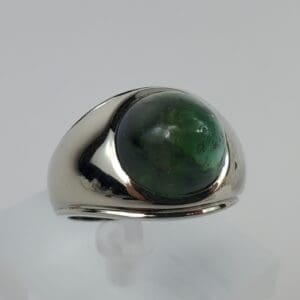 Silver ring with a green gemstone.