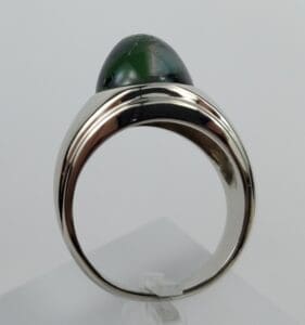 Silver ring with green gemstone cabochon.