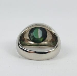 Silver ring with green gemstone inside.