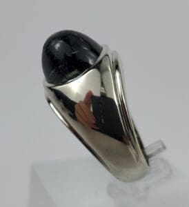 Silver ring with a black stone inset.