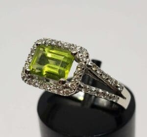 Silver ring with rectangular green gemstone.