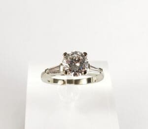 Diamond ring with a silver band displayed.