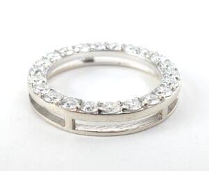 Silver ring with embedded clear gemstones.