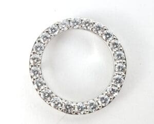 Diamond-studded circular ring on white background.