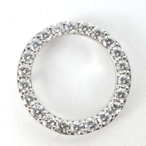 Diamond-studded circular ring on white background.
