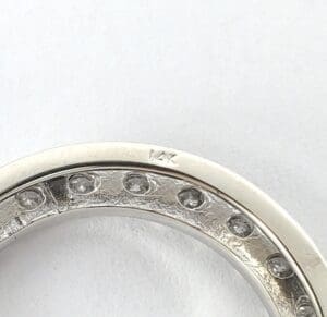 Silver ring with embedded diamonds, partial view.