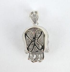 Silver skull pendant with gemstone details.