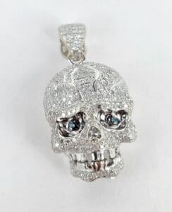 Diamond-encrusted skull pendant with blue eyes.