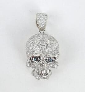 Diamond-encrusted skull pendant with blue eyes.