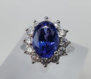 Blue gemstone ring with diamond accents.