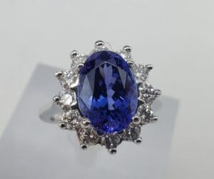 Blue gemstone ring with diamond accents.