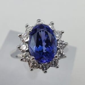 Blue gemstone ring with diamond accents.