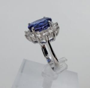 Silver ring with blue gemstone and diamonds.