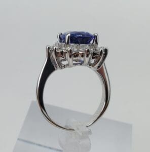 Silver ring with blue gemstone on display.
