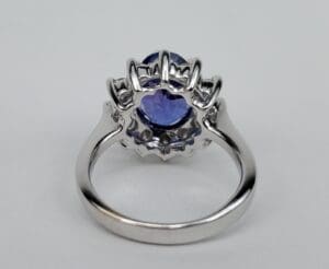 Silver ring with a purple gemstone setting.
