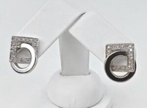 Silver earrings with square and circle design.