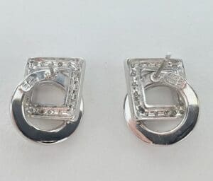 Silver geometric stud earrings on display.