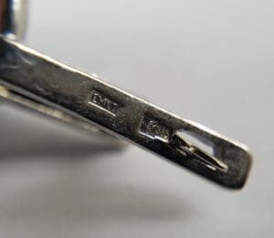 Close-up of metal item's engraved markings.