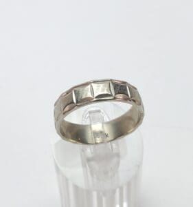 Gold ring with geometric pattern design.