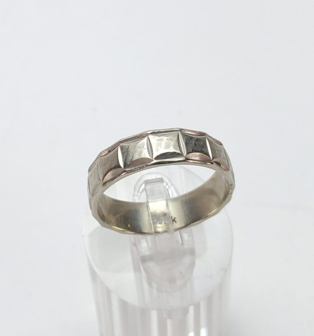 Gold ring with geometric pattern design.