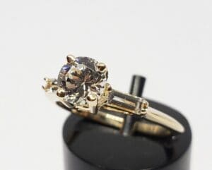 Gold ring with round and baguette diamonds.
