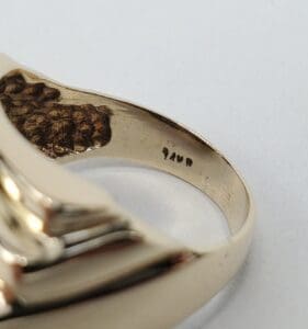 Gold ring with engraved inscription inside band.