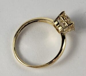 Gold ring with a large gemstone setting.