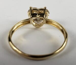 Gold ring with heart-shaped diamond setting.