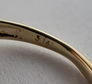 Gold ring with "14K" hallmark close-up.