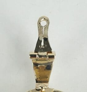 Gold pendant clasp with loop and hinge.