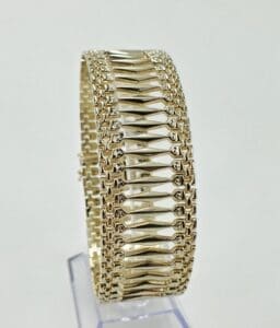 Gold bracelet with intricate geometric design.